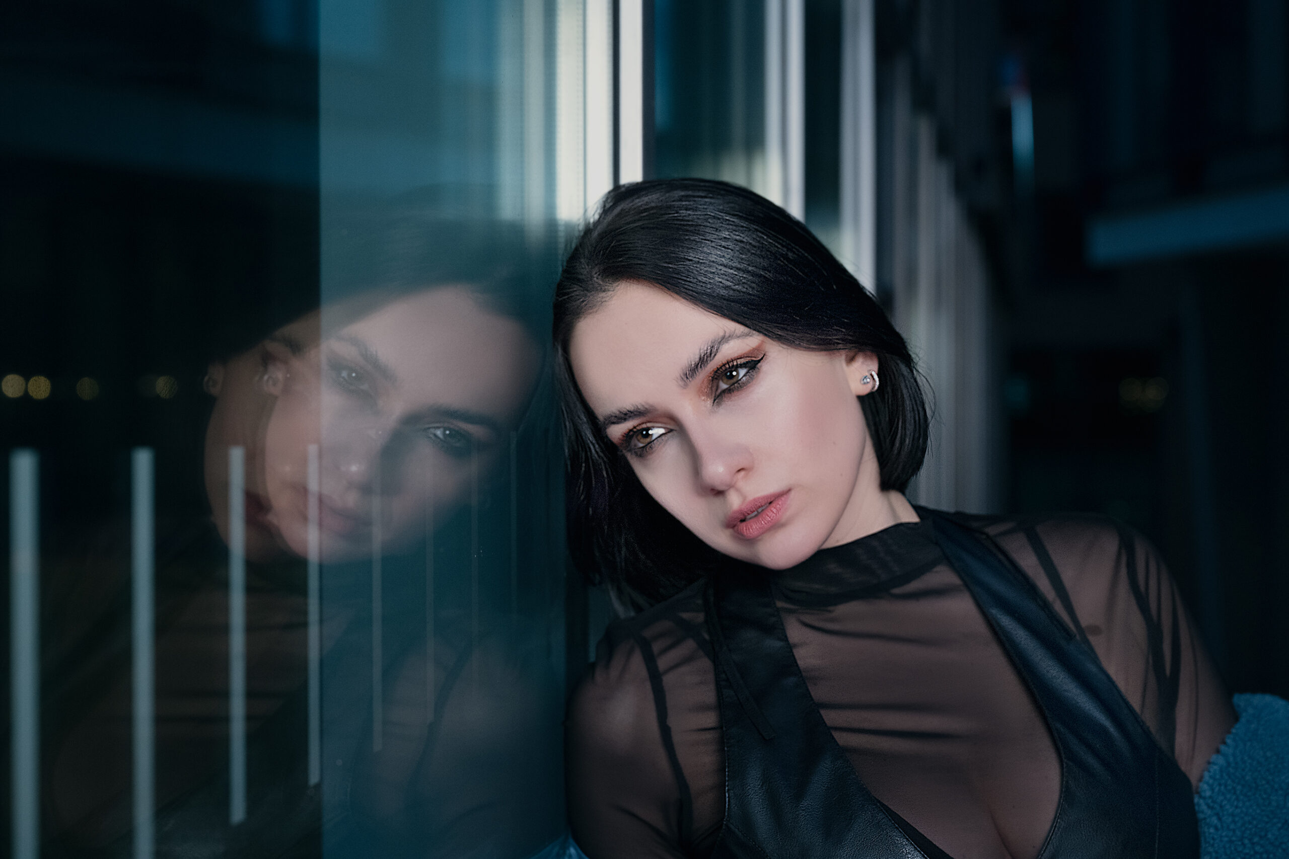 Image has a futuristic theme of dark blues, featuring a model in centre of image