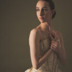 Preview of Erica, a ballerina in an ivory tutu looking over her shoulder