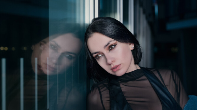 Image has a futuristic theme of dark blues, featuring a model in centre of image
